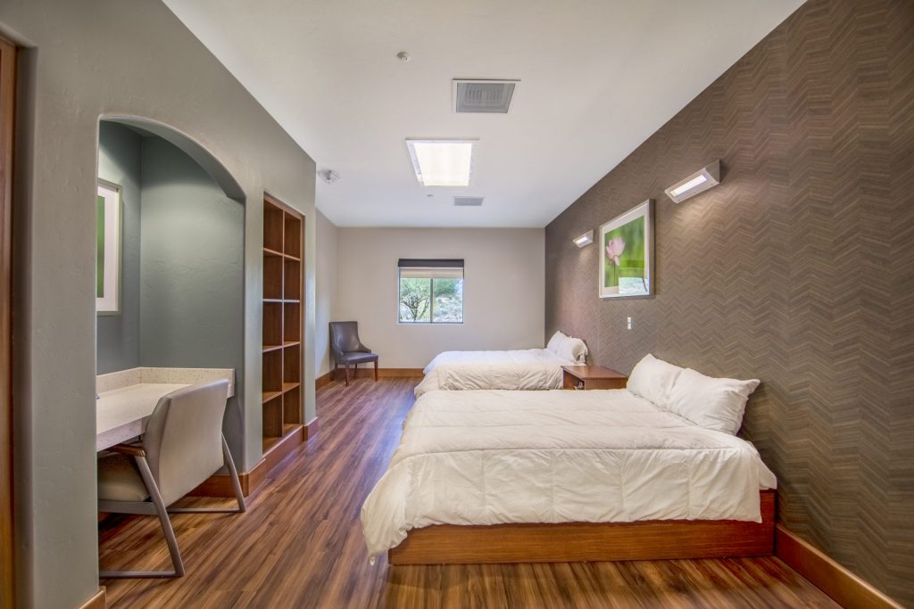 behavioral health facility bedroom with two queen beds