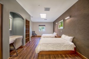 behavioral health facility bedroom with two queen beds