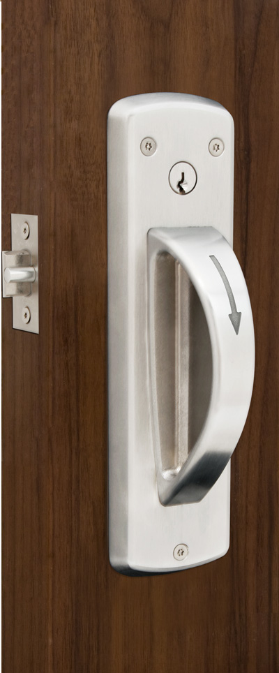 DH415 DH415 Ligature-Resistant Door Handle in sleek, stainless steel finish, securely mounted on a behavioral healthcare facility door. The handle features a smooth, sloped design that minimizes ligature risk, providing both safety and durability in high-security environments.