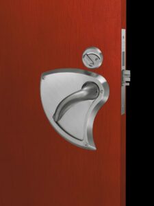 Ligature Resistant Integrated Door Lever – Mortise #DH510 installed on a door, featuring a streamlined, tamper-resistant design. The lever provides safety-focused access control with a smooth, contoured shape to minimize ligature risks, ideal for high-security environments.