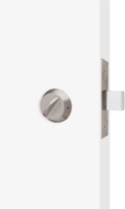 Close-up of the DH435 Deadbolt Lock with Ligature Resistant Thumb Turn installed on a smooth white door. The lock features a streamlined, tamper-resistant design, ideal for behavioral healthcare environments, emphasizing safety with a ligature-resistant thumb turn. The fixture sits flush against the door, minimizing gaps and protrusions to enhance security while providing ease of use for authorized access.
